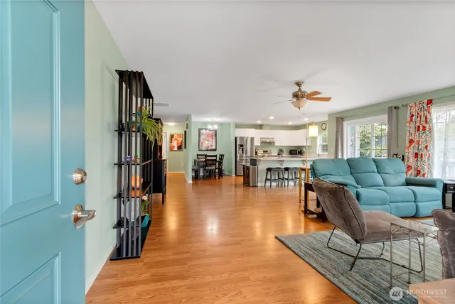 a living room with furniture and a book shelf