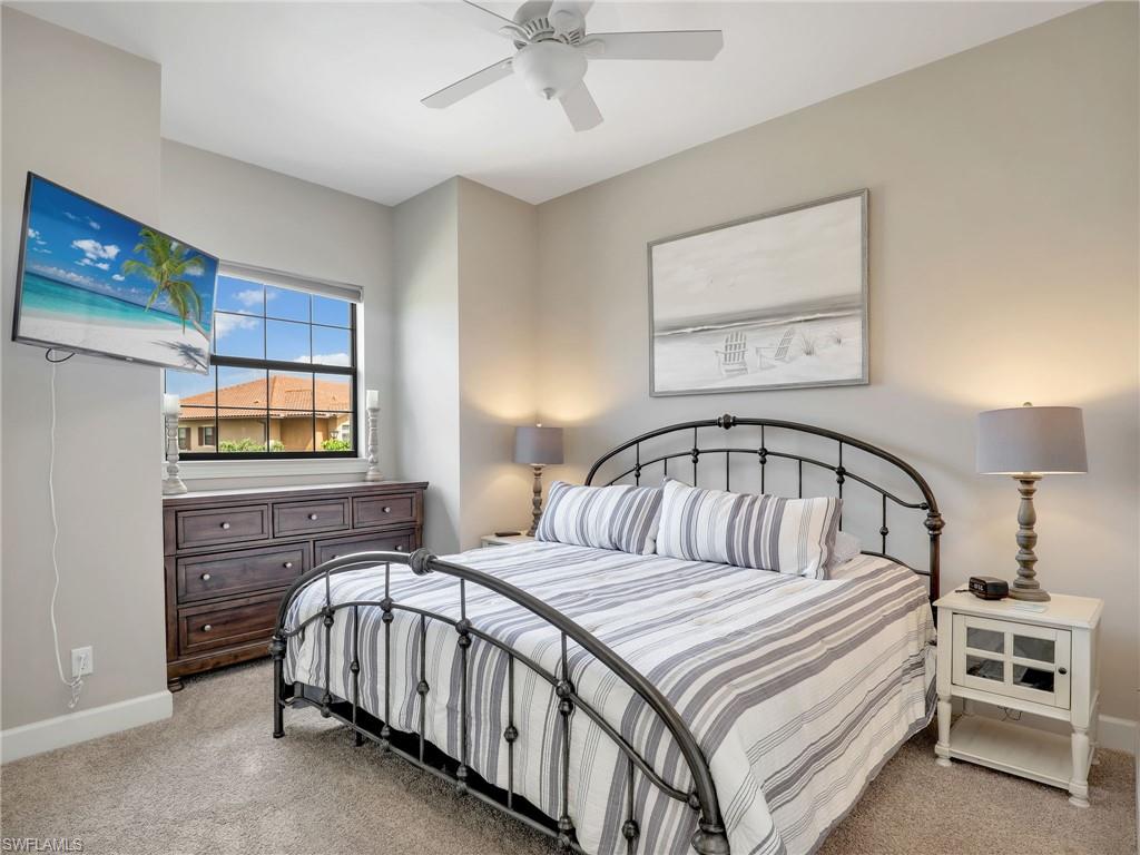 9685 Montelanico Loop, Unit 202 Naples, FL 34119 - Photo 10 of 41 a bedroom with a bed and a window
