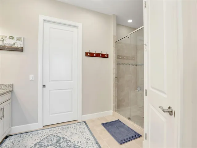 a bathroom with a granite countertop sink toilet mirror and bathtub