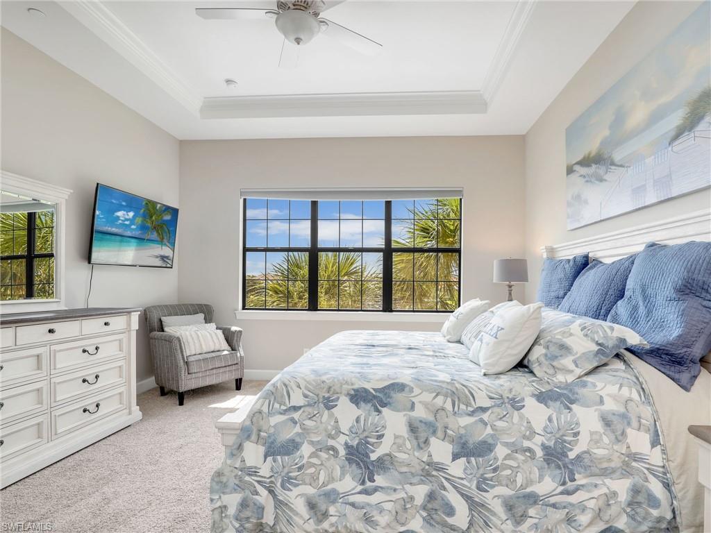 9685 Montelanico Loop, Unit 202 Naples, FL 34119 - Photo 17 of 41 a bedroom with a large bed and a window