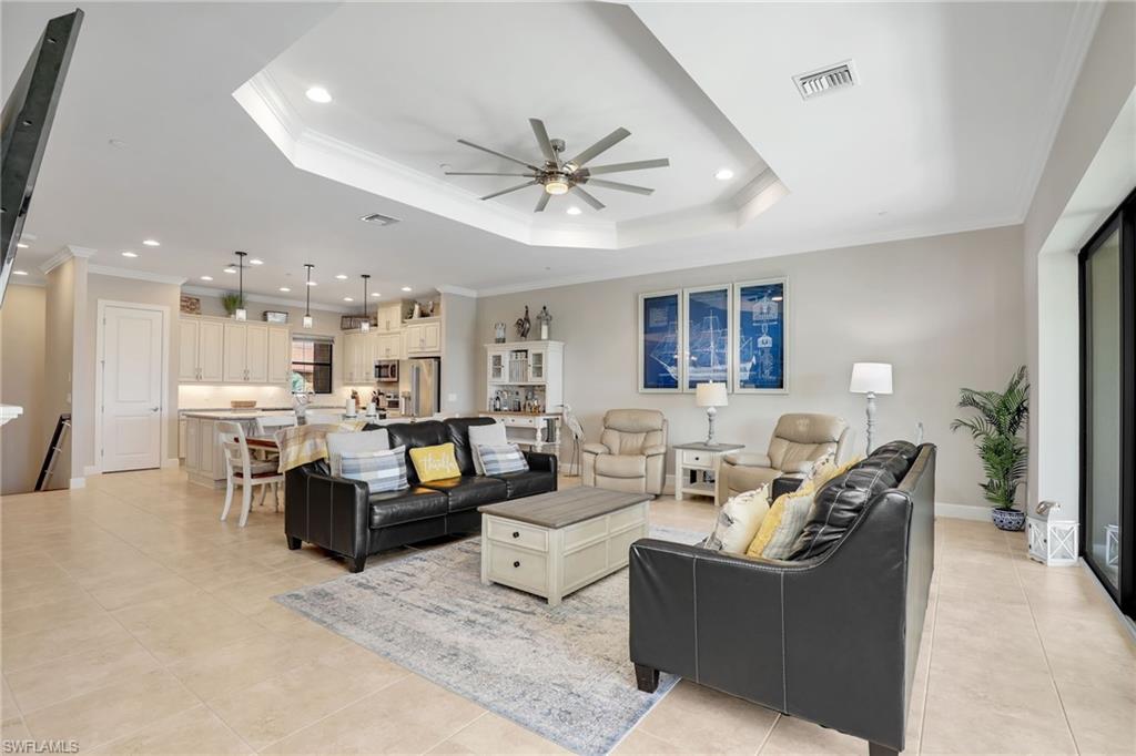 9685 Montelanico Loop, Unit 202 Naples, FL 34119 - Photo 22 of 41 a living room with fireplace furniture and a chandelier