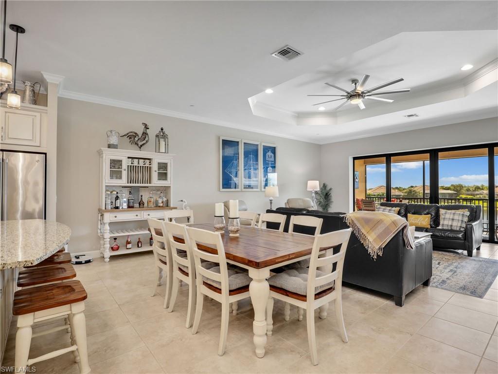 9685 Montelanico Loop, Unit 202 Naples, FL 34119 - Photo 25 of 41 a view of a dining room with furniture