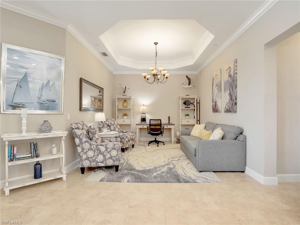 9685 Montelanico Loop, Unit 202 Naples, FL 34119 - Photo 27 of 41 a living room with furniture and a chandelier