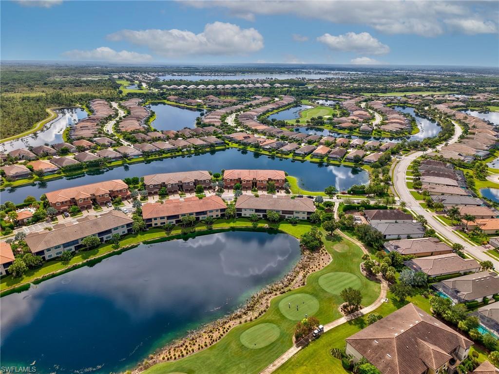 9685 Montelanico Loop, Unit 202 Naples, FL 34119 - Photo 32 of 41 an aerial view of a city with lots of residential buildings ocean and mountain view in back