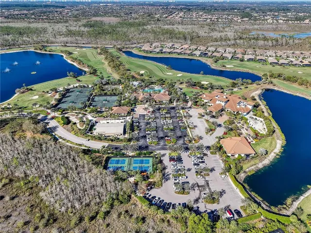an aerial view of residential houses with outdoor space and swimming pool