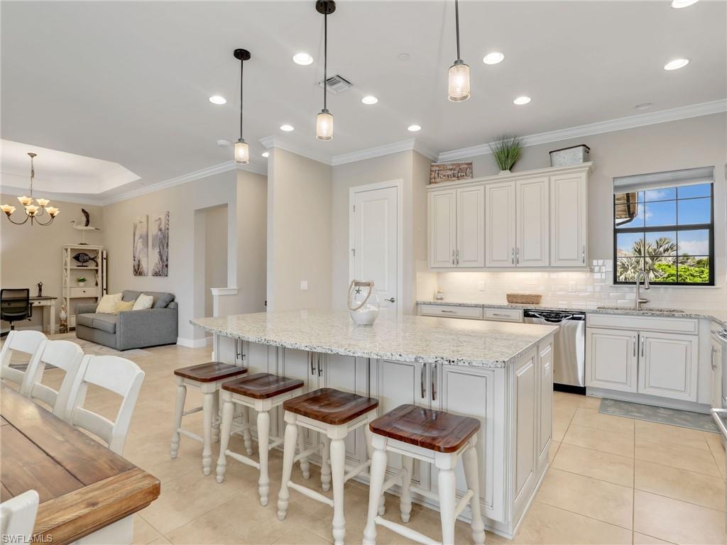9685 Montelanico Loop, Unit 202 Naples, FL 34119 - Photo 41 of 41 a kitchen with a sink and chairs