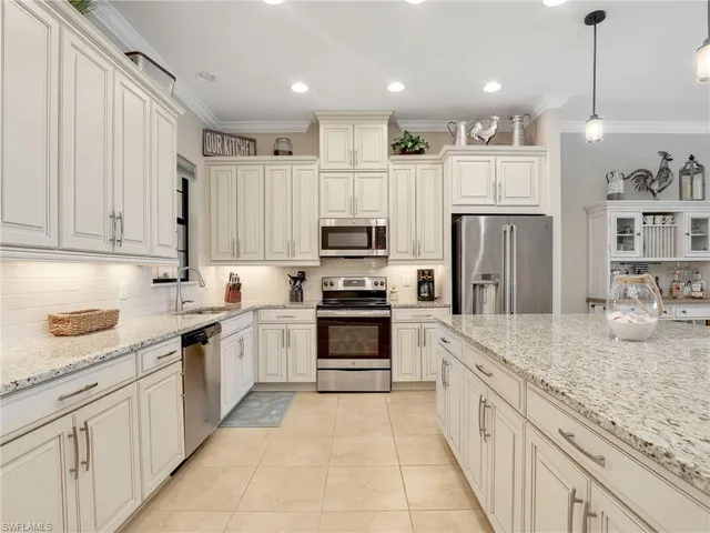 a kitchen with a sink and chairs