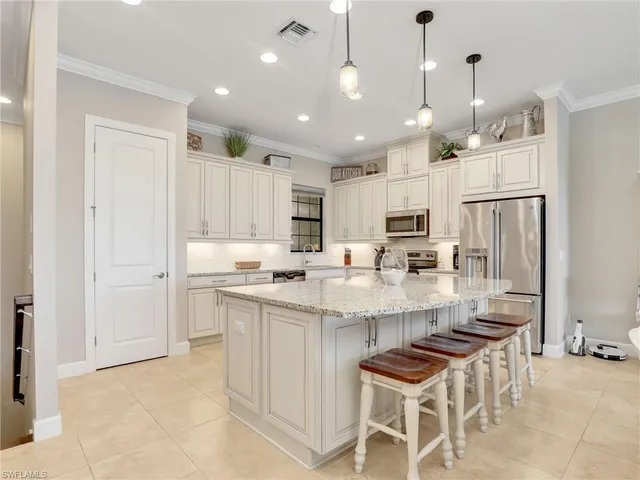 a large kitchen with cabinets stainless steel appliances and a counter space
