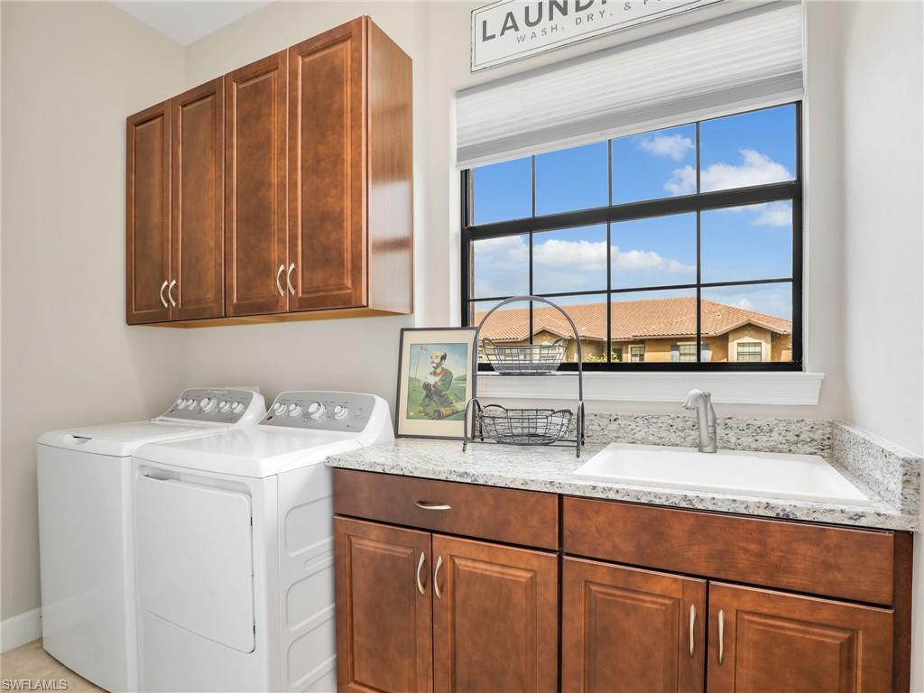 9685 Montelanico Loop, Unit 202 Naples, FL 34119 - Photo 9 of 41 a kitchen with a sink cabinets and window