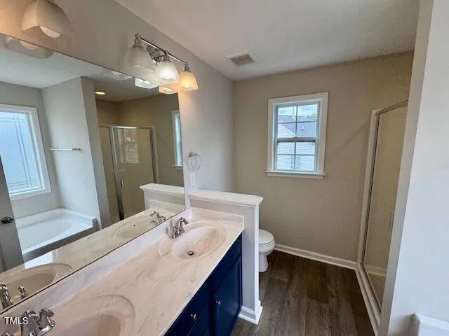 a en suite bathroom with a double vanity sink and a mirror