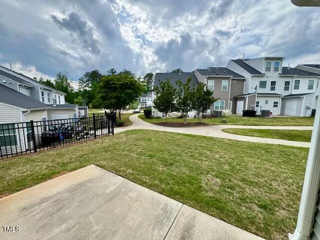 a view of a house with a swimming pool and a yard