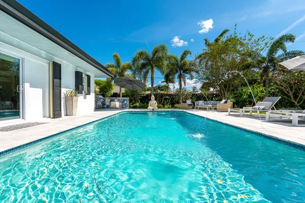 a swimming pool with outdoor seating and yard