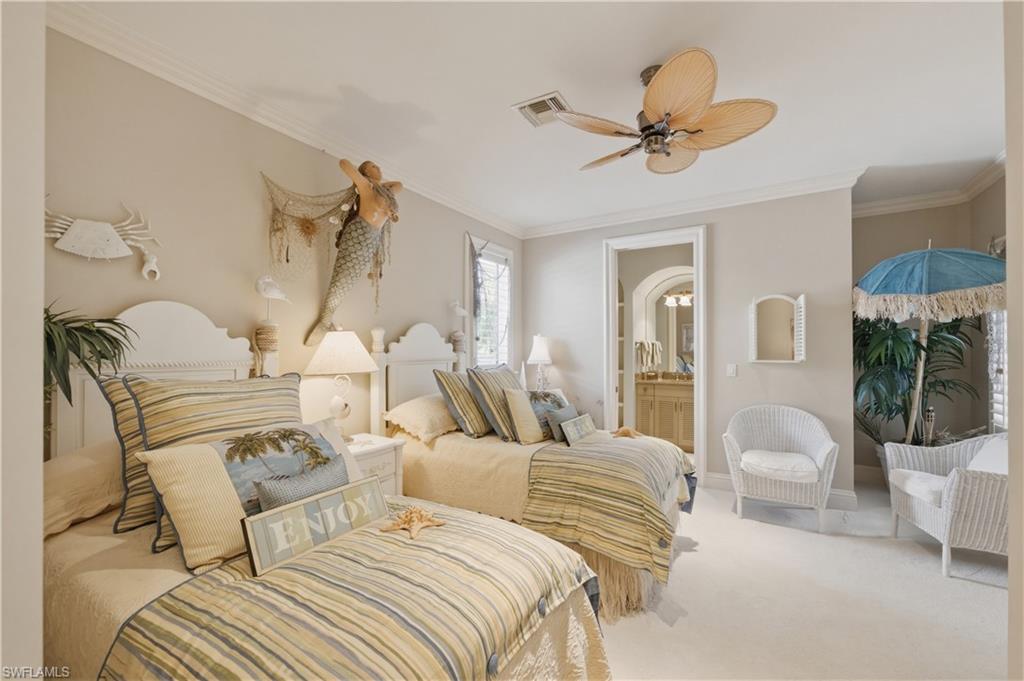 361 Pirates Bight Naples, FL 34103 - Photo 35 of 45 a bedroom with a bed and a chandelier