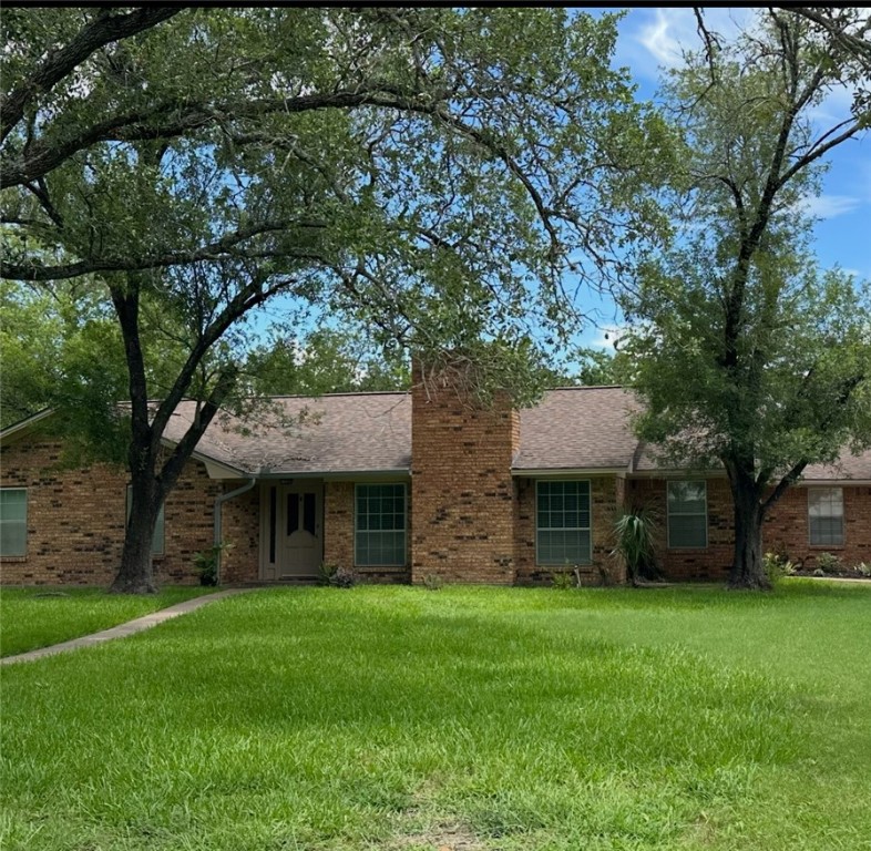 1010 Holt Street College Station, TX 77840 - Photo 1 of 14 a front view of a house with a garden and tree