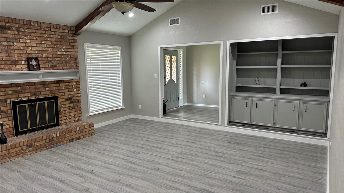 1010 Holt Street College Station, TX 77840 - Photo 5 of 14 wooden floor fireplace and windows in an empty room