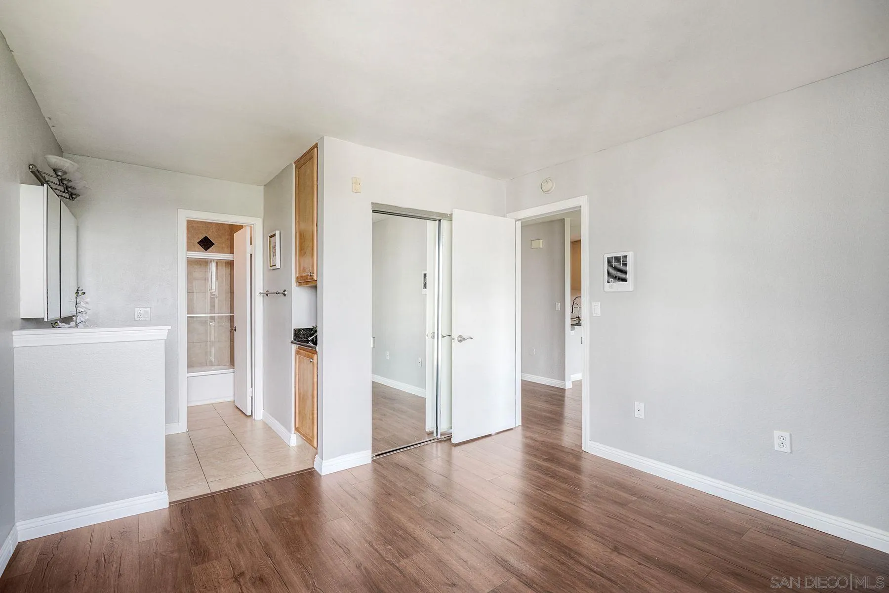 4860 Rolando Court, Unit 75 San Diego, CA 92115 - Photo 11 of 20 a view of empty room with wooden floor