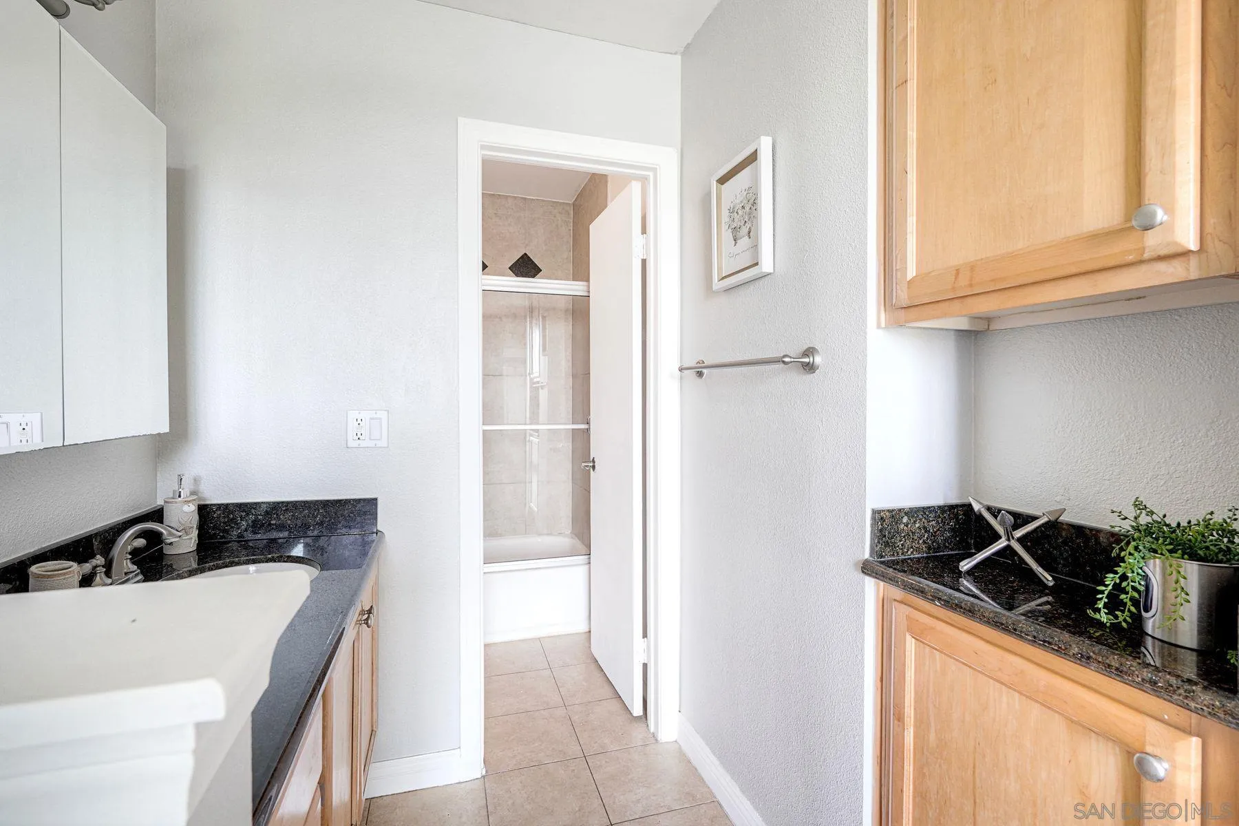 4860 Rolando Court, Unit 75 San Diego, CA 92115 - Photo 13 of 20 a kitchen with stainless steel appliances granite countertop a sink stove and cabinets
