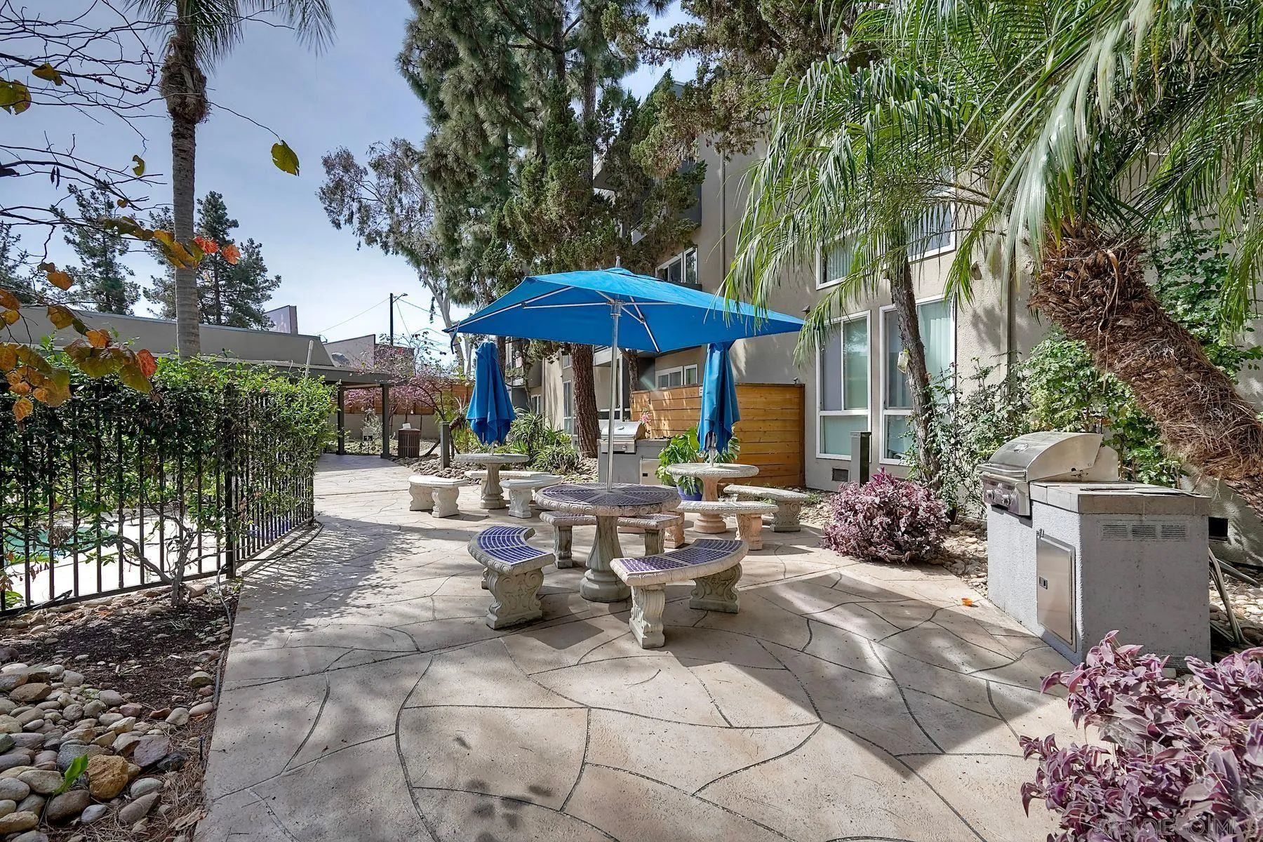 4860 Rolando Court, Unit 75 San Diego, CA 92115 - Photo 18 of 20 a view of a tables and chairs under an umbrella