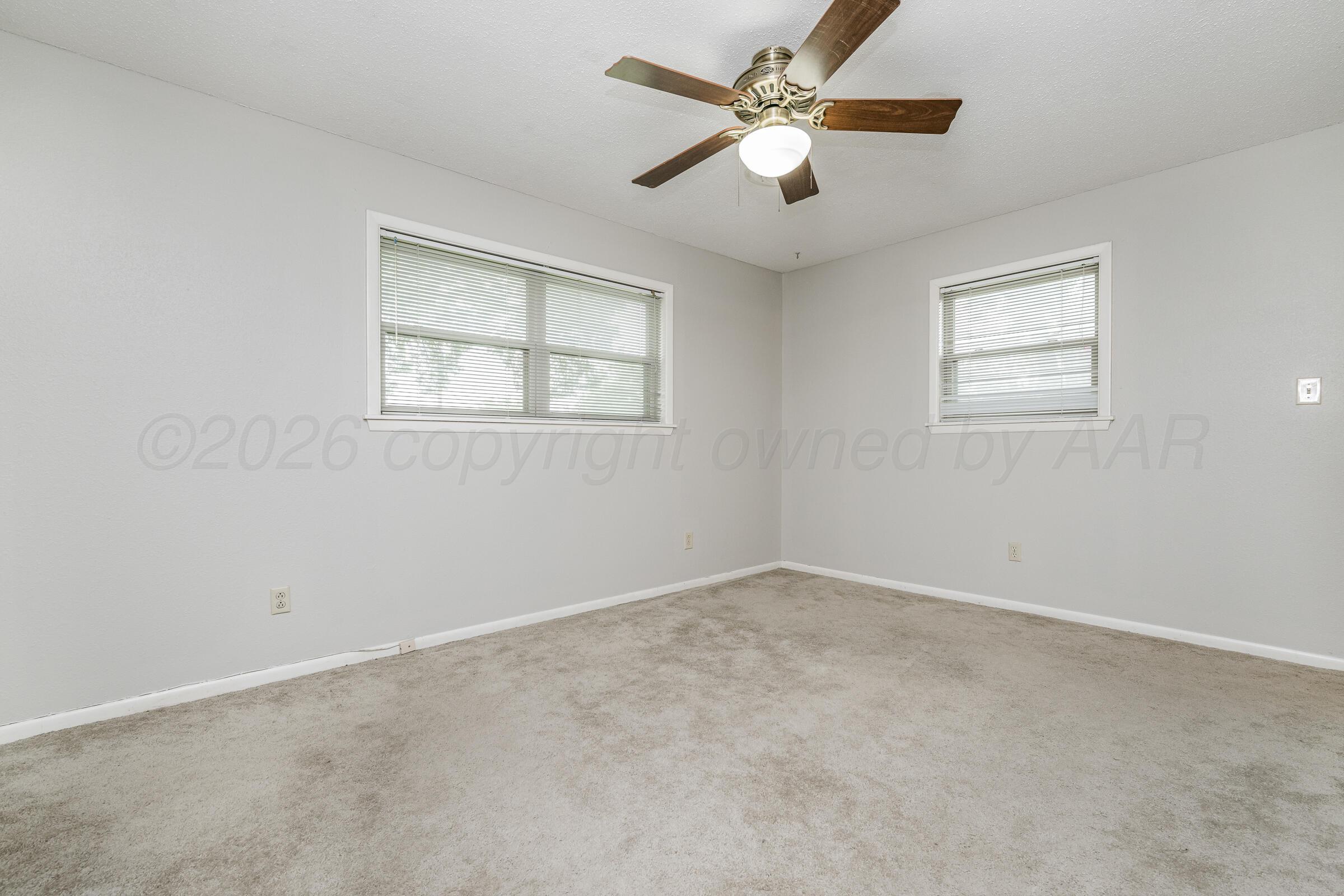 4400 West Farmers Avenue Amarillo, TX 79110 - Photo 25 of 27 an empty room with a window and a fan