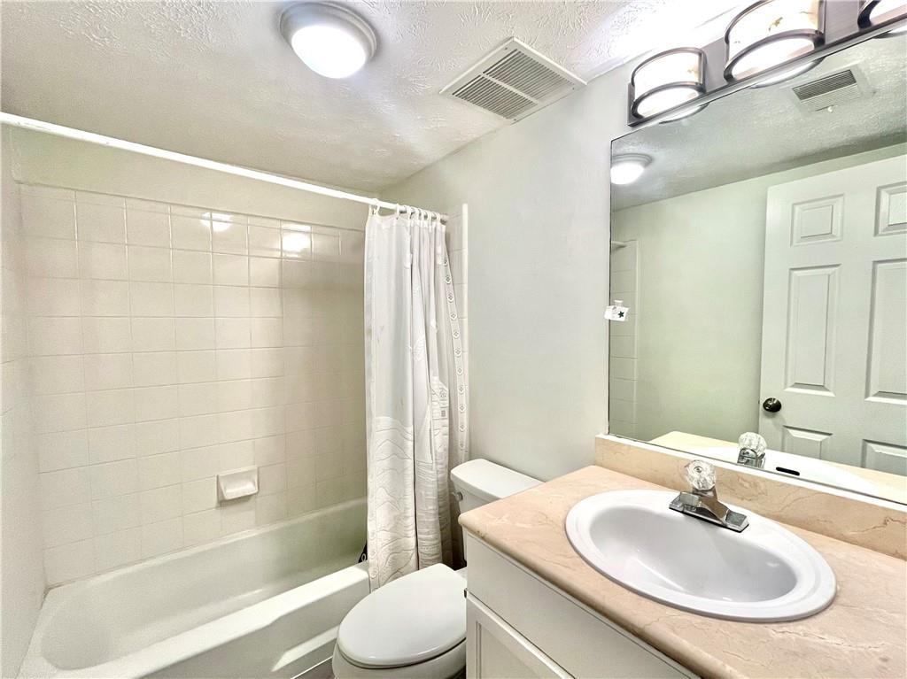 1150 Collier Road Northwest, Unit 2J Atlanta, GA 30318 - Photo 12 of 33 a bathroom with a sink and a mirror