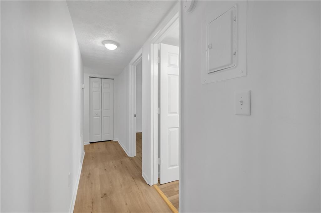 1150 Collier Road Northwest, Unit 2J Atlanta, GA 30318 - Photo 12 of 41 a view of a hallway with wooden floor