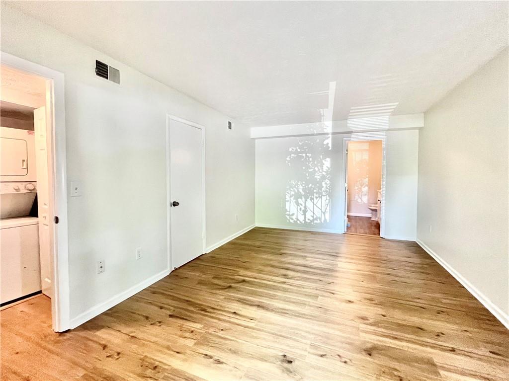 1150 Collier Road Northwest, Unit 2J Atlanta, GA 30318 - Photo 14 of 33 a view of empty room with wooden floor