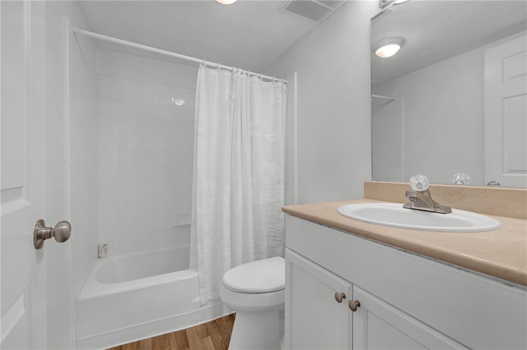 1150 Collier Road Northwest, Unit 2J Atlanta, GA 30318 - Photo 15 of 41 a bathroom with a sink a toilet and shower