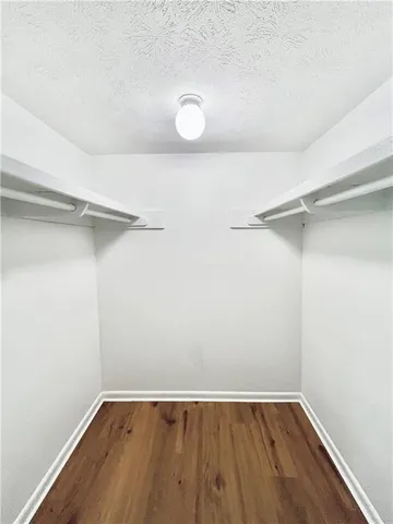 a view of a small space with wooden floor and a window