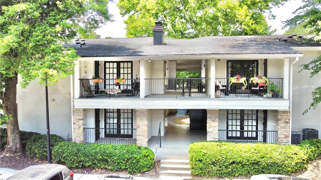 1150 Collier Road Northwest, Unit 2J Atlanta, GA 30318 - Photo 25 of 41 a front view of a house with garden