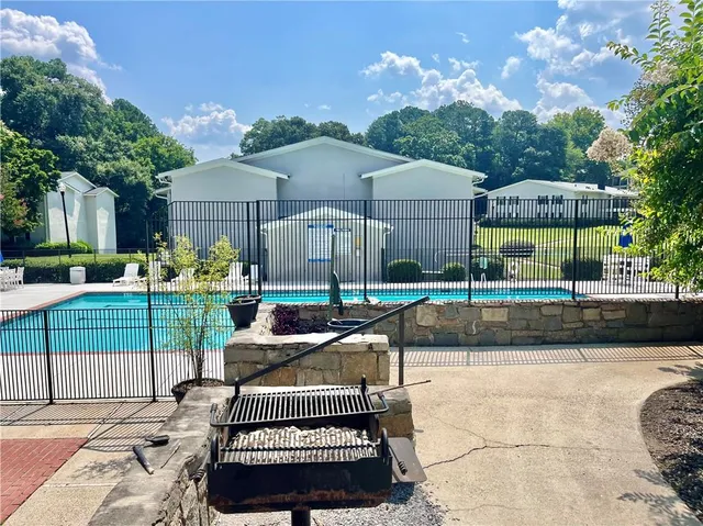 a view of a house with backyard and sitting area