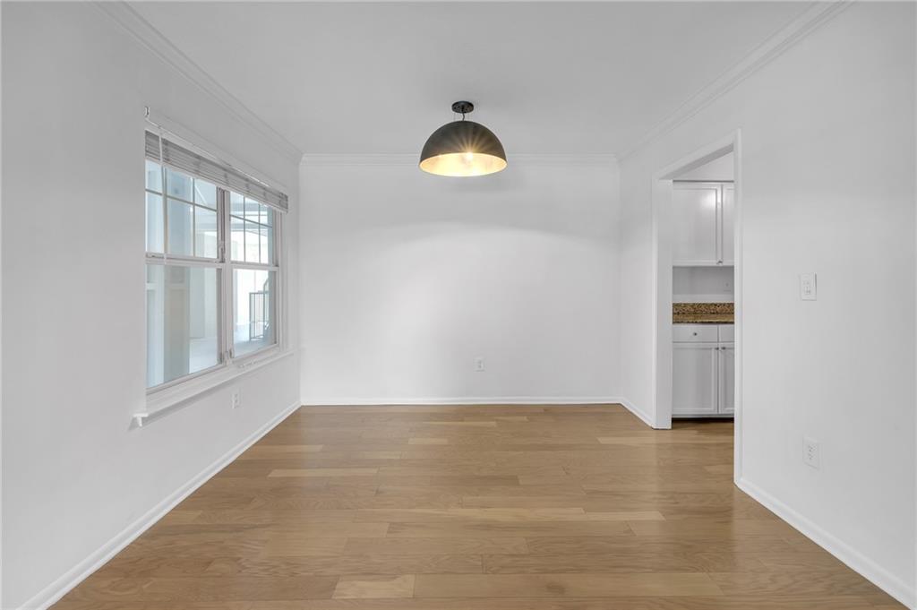 1150 Collier Road Northwest, Unit 2J Atlanta, GA 30318 - Photo 3 of 41 a view of a room with wooden floor and windows