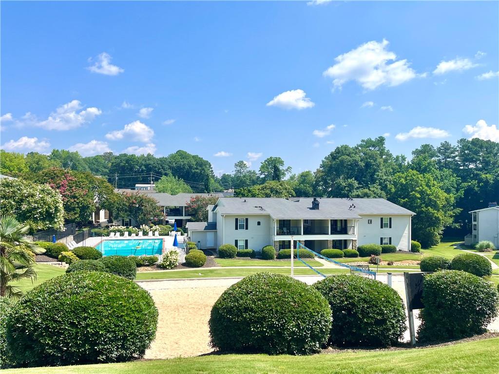 1150 Collier Road Northwest, Unit 2J Atlanta, GA 30318 - Photo 31 of 33 front view of a house with a yard