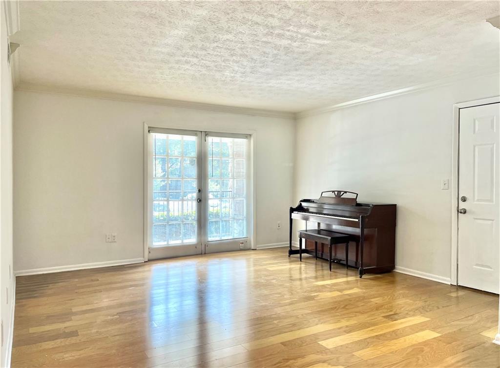 1150 Collier Road Northwest, Unit 2J Atlanta, GA 30318 - Photo 5 of 33 a view of a workspace with furniture and a window