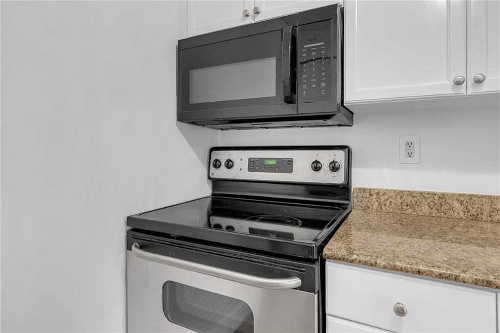 1150 Collier Road Northwest, Unit 2J Atlanta, GA 30318 - Photo 6 of 41 a stove top oven sitting inside of a kitchen