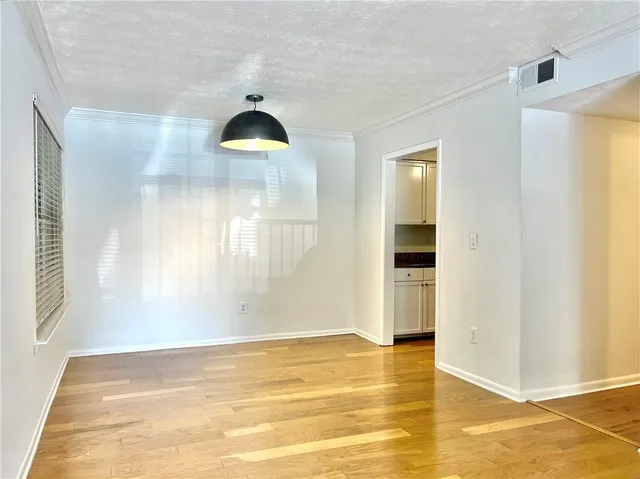 a view of a livingroom with wooden floor and a window