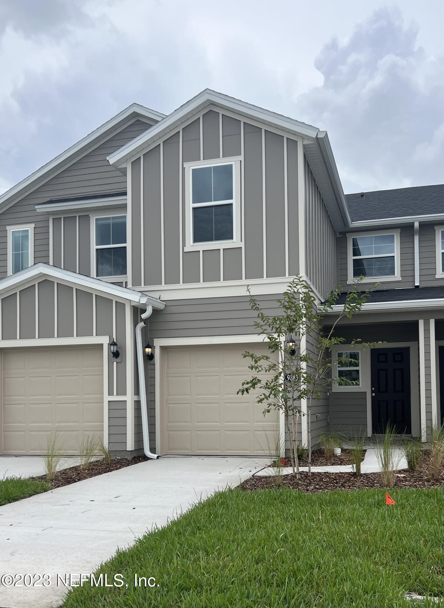 9883 Fiddleback Lane Jacksonville, FL 32222 - Photo 1 of 12 a front view of a house with a yard and garage