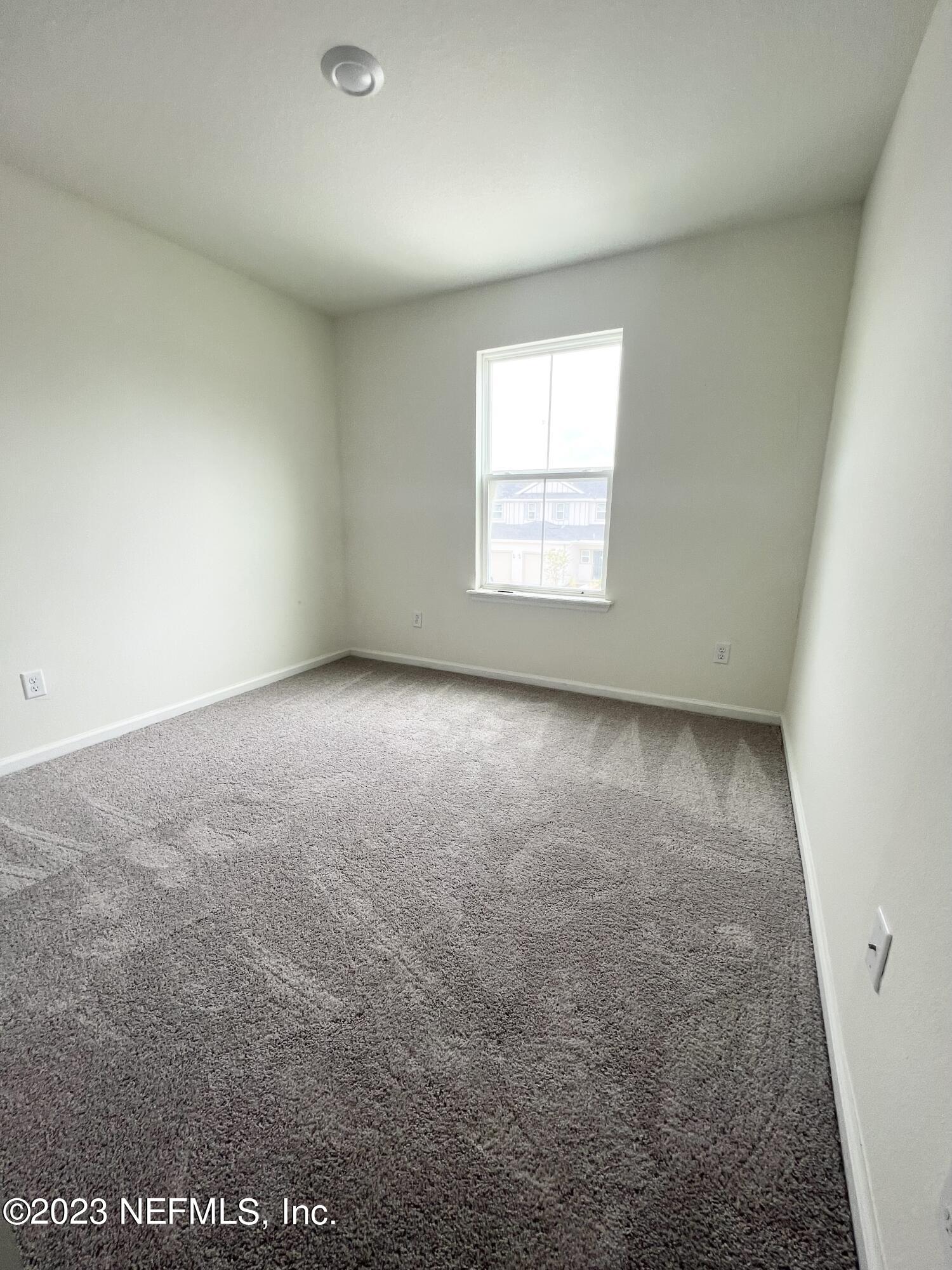 9883 Fiddleback Lane Jacksonville, FL 32222 - Photo 7 of 12 an empty room with a window