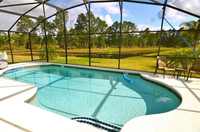 a view of a swimming pool with a yard