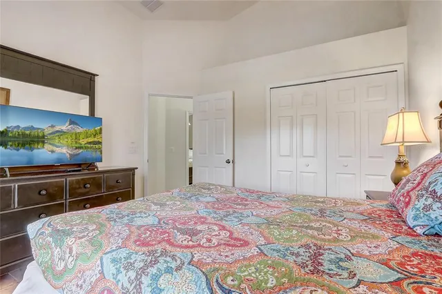 a bedroom with a bed table and window