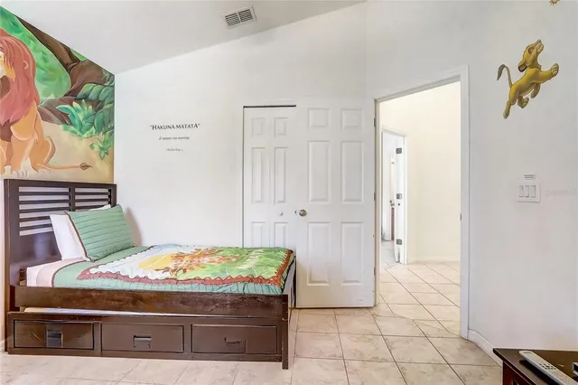 a view of a house with a yard and palm trees