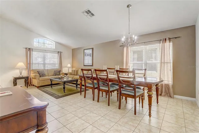 a very nice looking dining room with furniture window and outside view