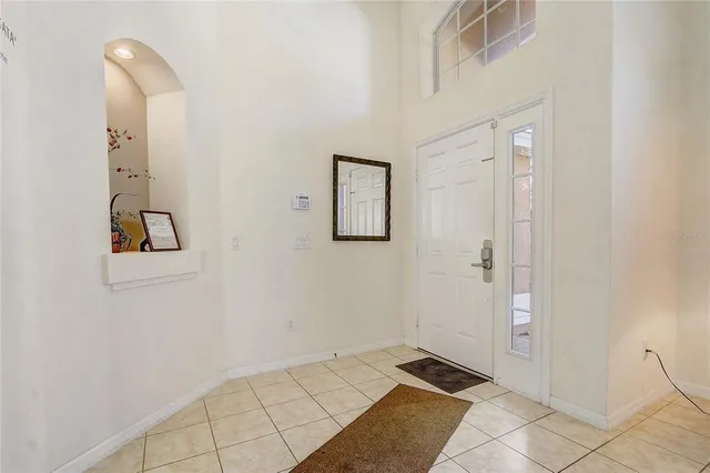 a living room with furniture a dining table and a window