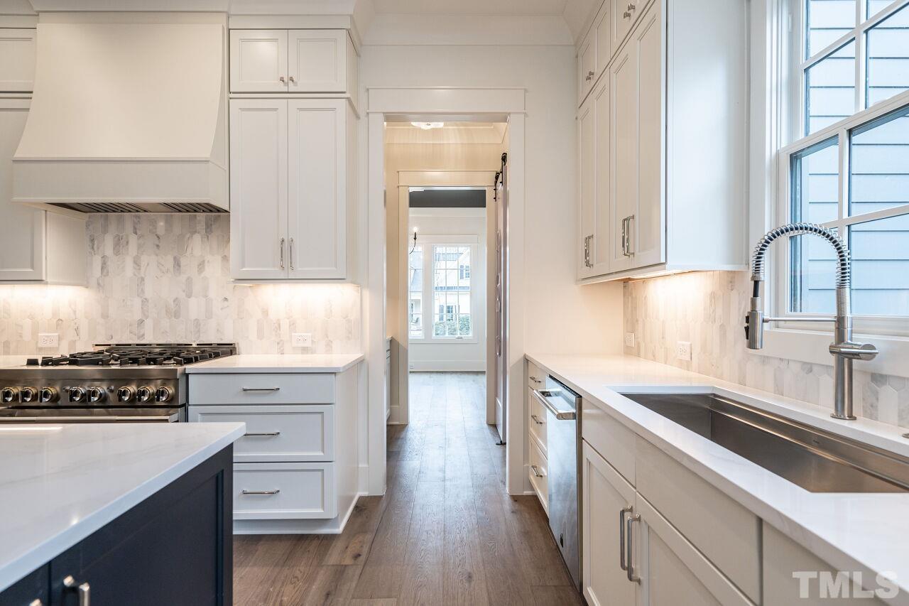 1104 Shelley Road Raleigh, NC 27609 - Photo 17 of 45 a kitchen with stainless steel appliances granite countertop a stove a sink and a refrigerator