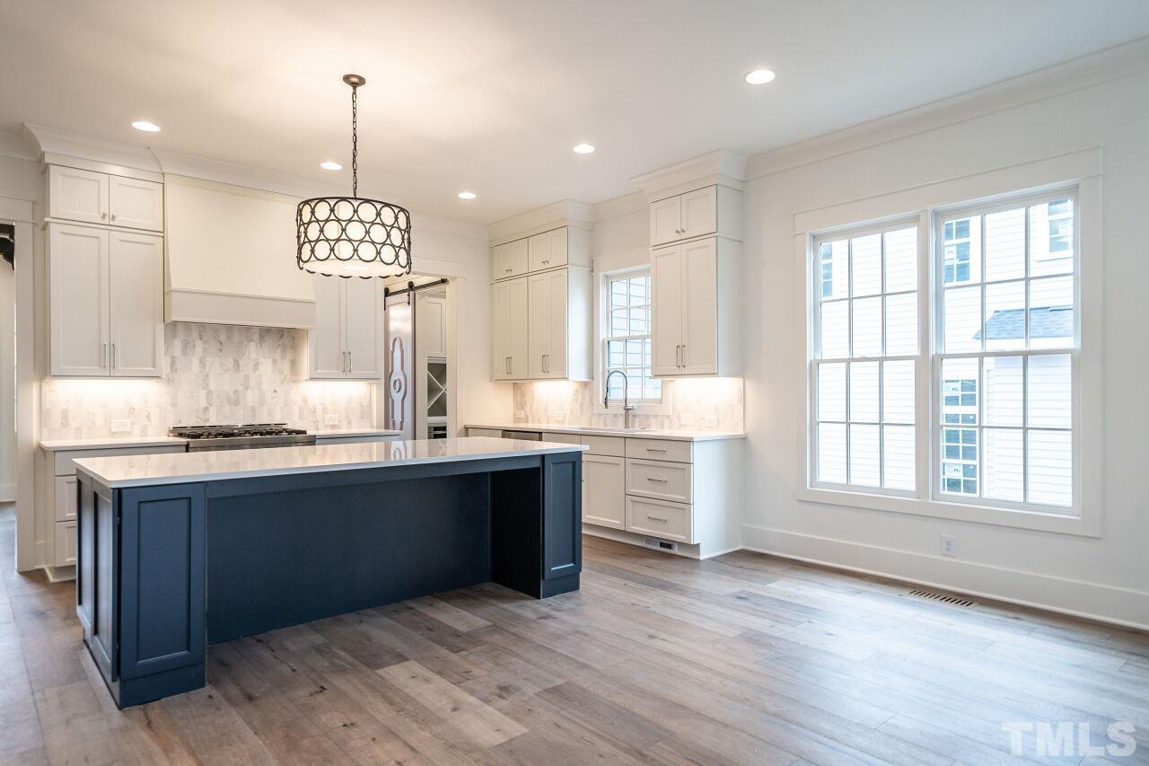 1104 Shelley Road Raleigh, NC 27609 - Photo 19 of 45 a view of large kitchen with granite countertop stainless steel appliances and wooden floor
