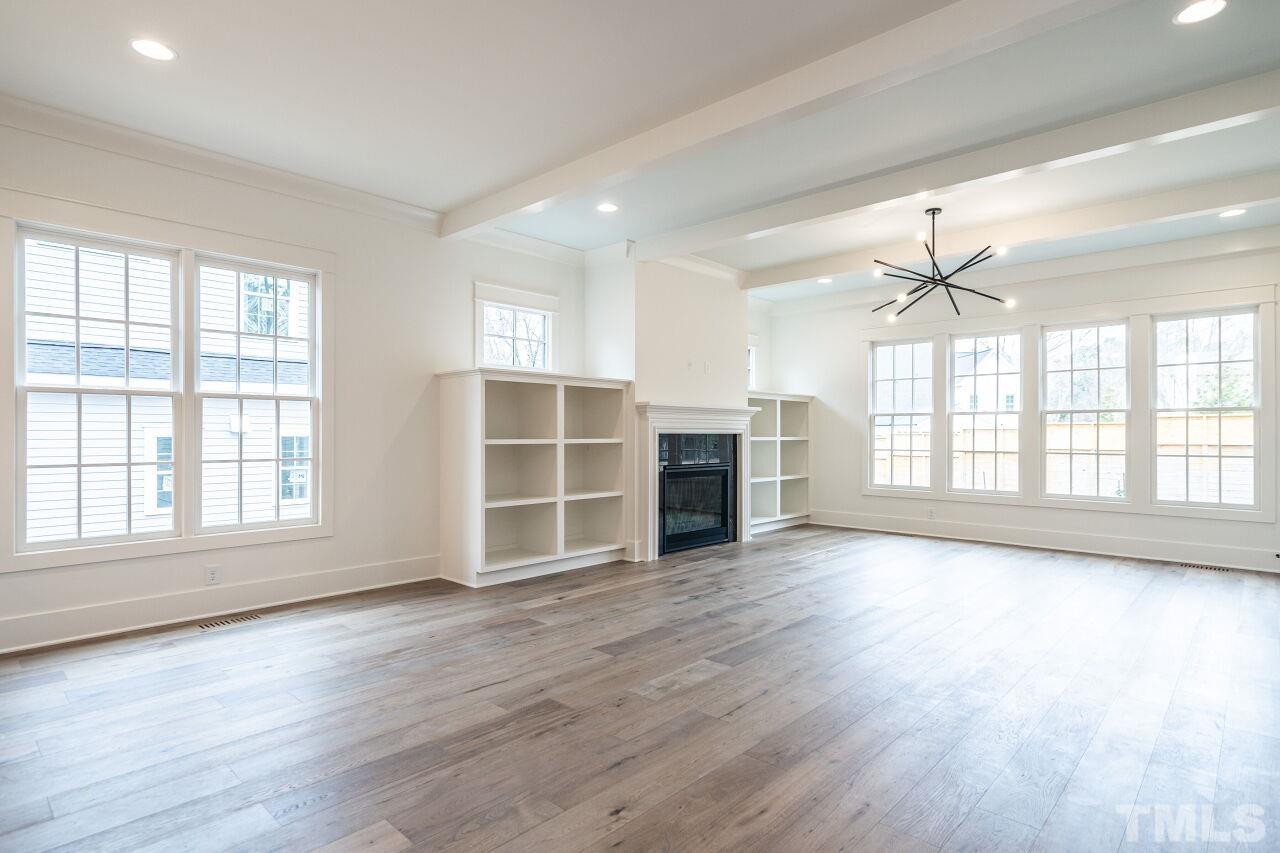 1104 Shelley Road Raleigh, NC 27609 - Photo 20 of 45 an empty room with wooden floor and windows