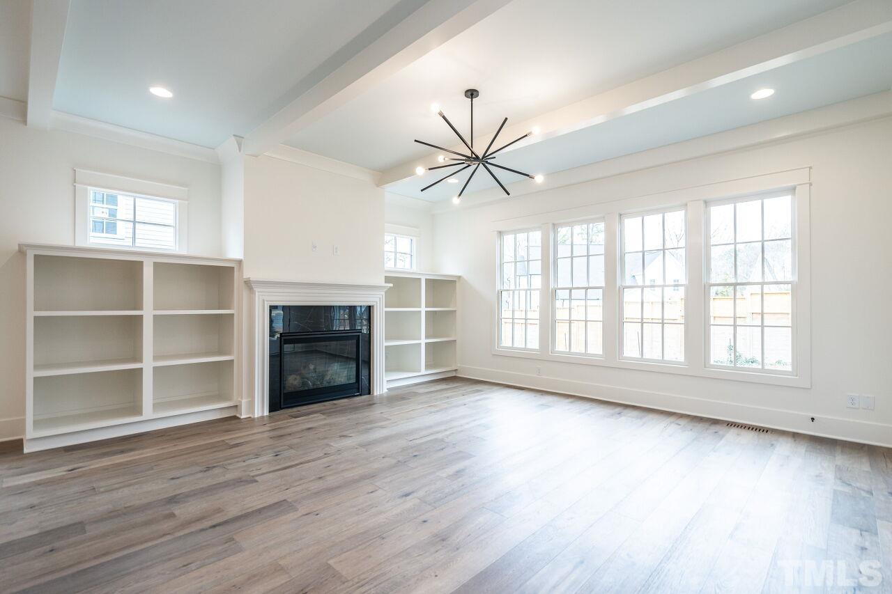 1104 Shelley Road Raleigh, NC 27609 - Photo 22 of 45 a view of an empty room with a window and wooden floor