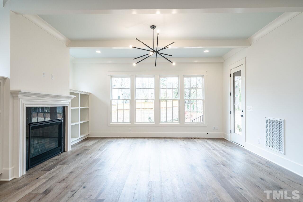 1104 Shelley Road Raleigh, NC 27609 - Photo 23 of 45 an empty room with wooden floor and a window