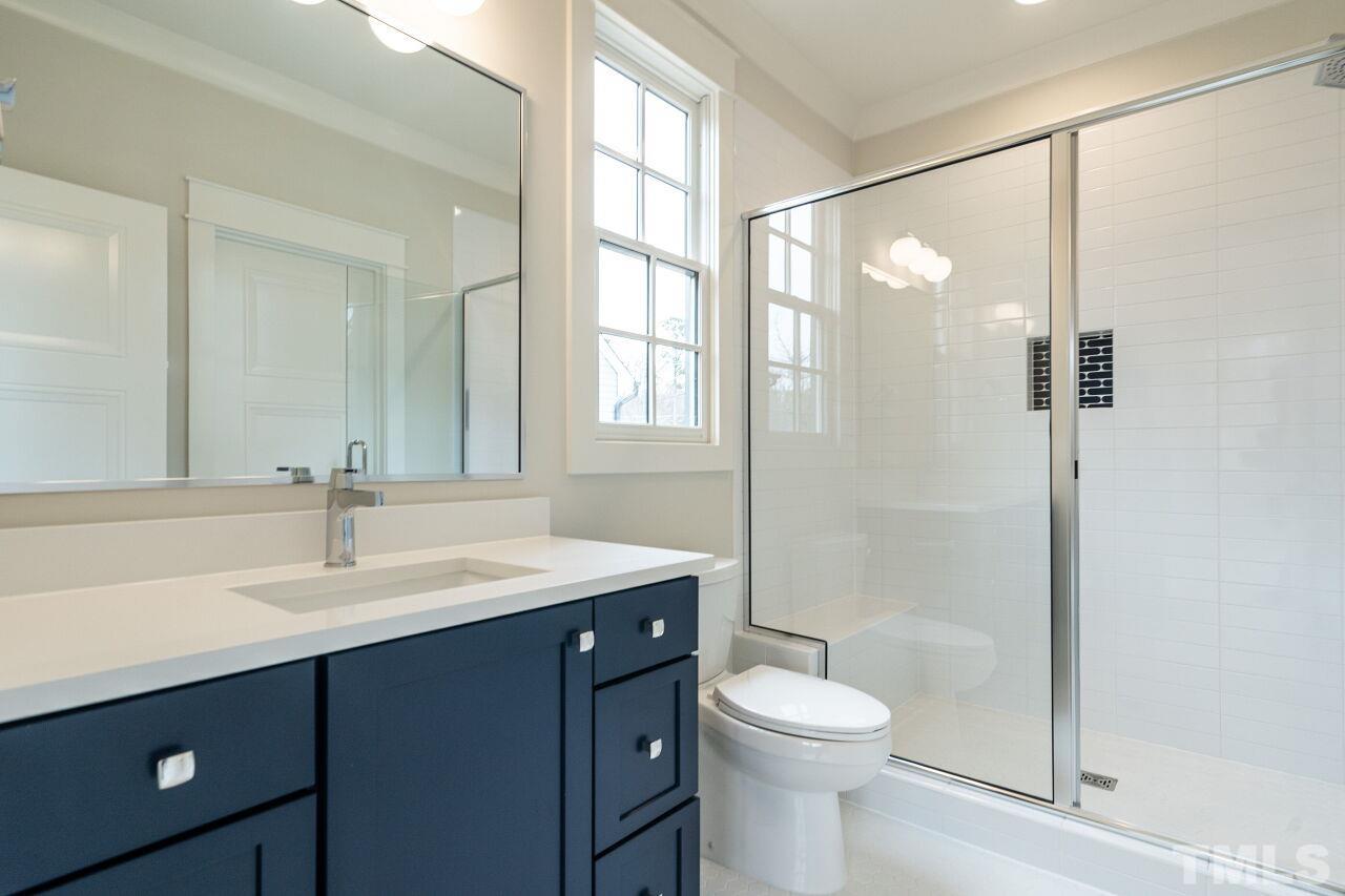 1104 Shelley Road Raleigh, NC 27609 - Photo 31 of 45 a bathroom with a sink toilet and shower