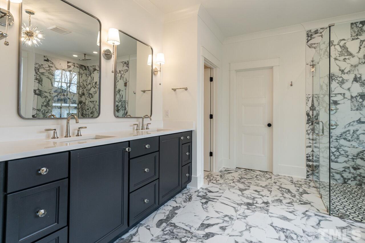 1104 Shelley Road Raleigh, NC 27609 - Photo 33 of 45 a bathroom with a sink and a mirror