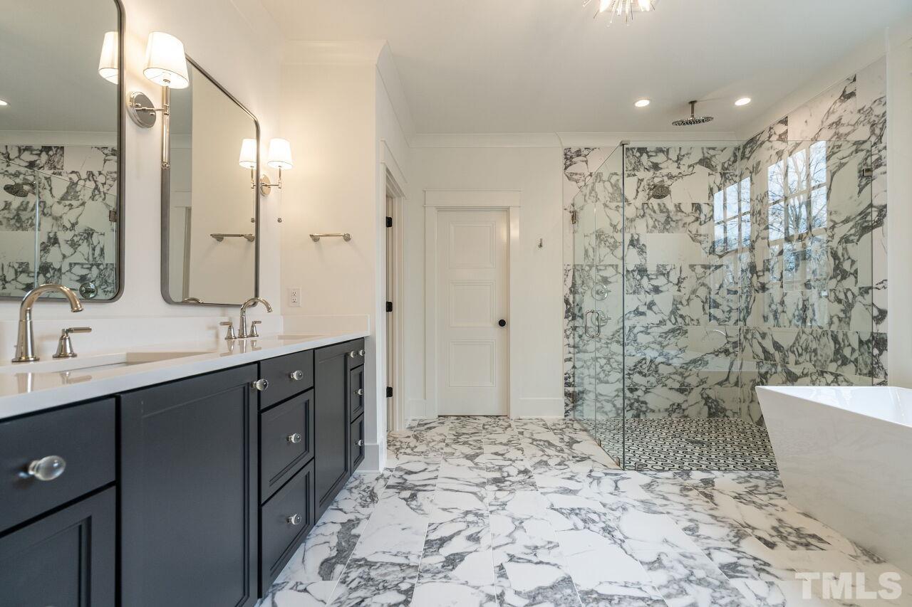 1104 Shelley Road Raleigh, NC 27609 - Photo 34 of 45 a bathroom with a bathtub sink mirror and shower